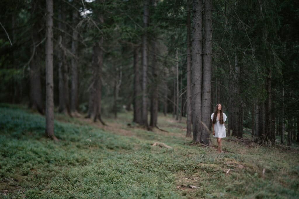 Wellness forest bathing - A woman stands in the forest, all ....